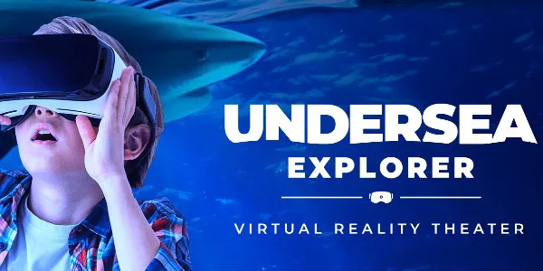 A young child looking up with a virtual reality headset on his head with an ocean background. Text on image shows: Undersea Explorer Virtual Reality Theater